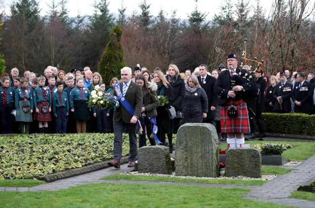 A piper plays as people attend a service to mark the 30th anniversary of the Lockerbie Air Disaster at the Memorial Garde in Dryfesdale Cemetery. Picture: Jane Barlow