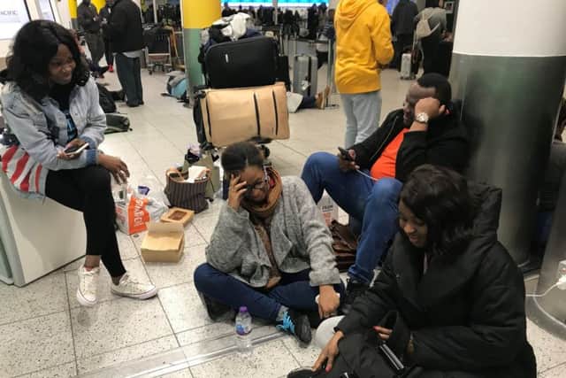 Bride-to-be Tayo Abraham (centre) surrounded friends, part of the wedding party, at Gatwick Airport who were due to fly to Marrakesh in Morocco but are facing another night of uncertainty following flight disruption caused by drones. Picture: Emma Bowden/PA Wire