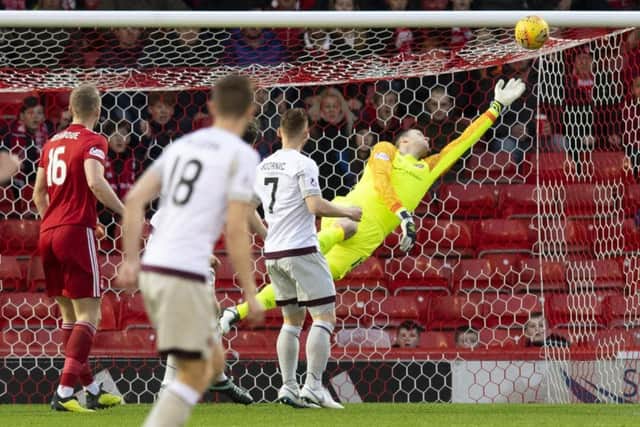 Aberdeen striker Sam Cosgrove scores past Hearts goalkeeper Colin Doyle to make it 1-0. Picture: SNS