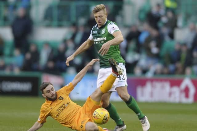 Livingstons Steven Lawless slides in to challenge Sean Mackie, who was making his first start for Hibernian in Saturdays 1-1 draw. Picture: Neil Hanna