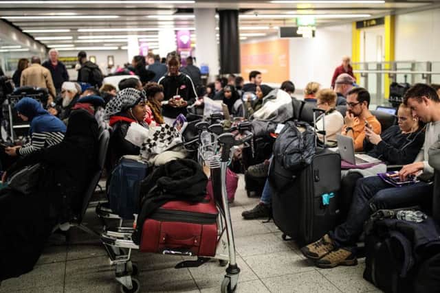 Stock image of passengers waiting with their luggage (Photo by Jack Taylor/Getty Images)