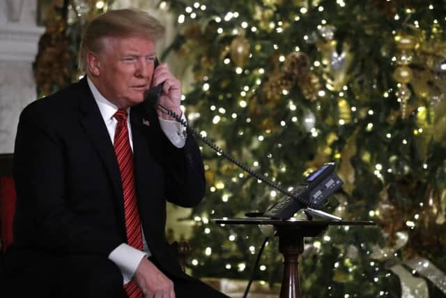 President Donald Trump took phone calls from children eager to hear the whereabouts of Santa. Picture: AP