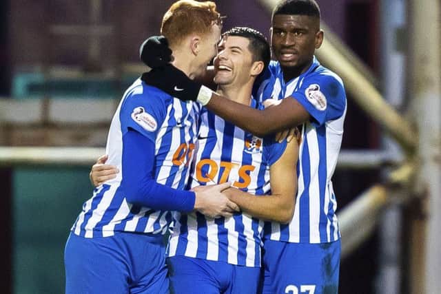 Jordan Jones (centre) celebrates with teammates Scott Boyd (L) and Aaron Tshibola after grabbing the only goal of the game. Picture: SNS Group