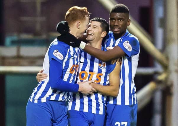 Jordan Jones (centre) celebrates with teammates Scott Boyd (L) and Aaron Tshibola after grabbing the only goal of the game. Picture: SNS Group