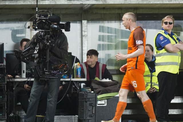 Dundee United's Willo Flood leaves the pitch after being sent off in his side's play-off semi-final. Picture: SNS