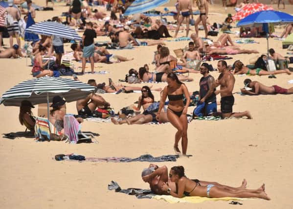Sunbathers at Bondi Beach in Sydney. A British man was found walking naked in a nearby street. Picture: Peter Parks/Getty Images