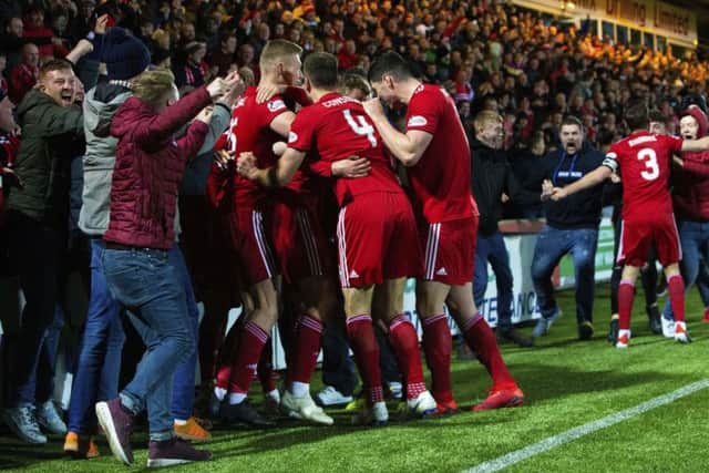 Aberdeen celebrate with their support after James Wilson fires them in front. Pic: SNS/Bruce White
