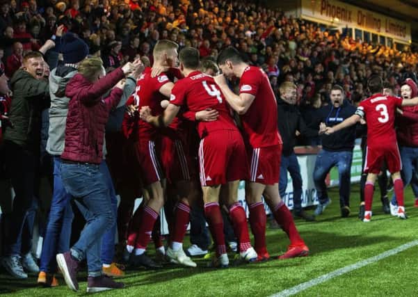 Aberdeen celebrate with their support after James Wilson fires them in front. Pic: SNS/Bruce White