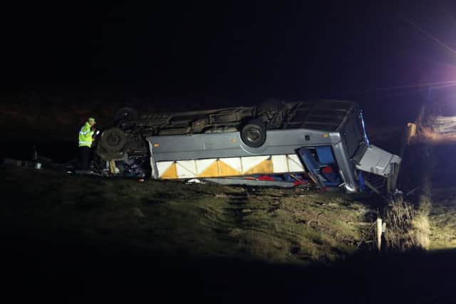 The scene on the A6089, between Carfraemill and Gordon in Scotland, where one man died and 23 people were taken to hospital after a private minibus overturned. Picture: Andrew Milligan/PA Wire