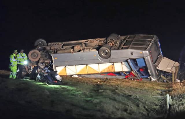 The scene on the A6089, between Carfraemill and Gordon in Scotland, where one man died and 23 people were taken to hospital after a private minibus overturned. Picture: Andrew Milligan/PA Wire