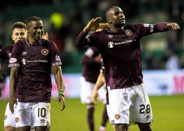 Hearts defender Clevid Dikamona, right, celebrates at full-time. Picture: SNS
