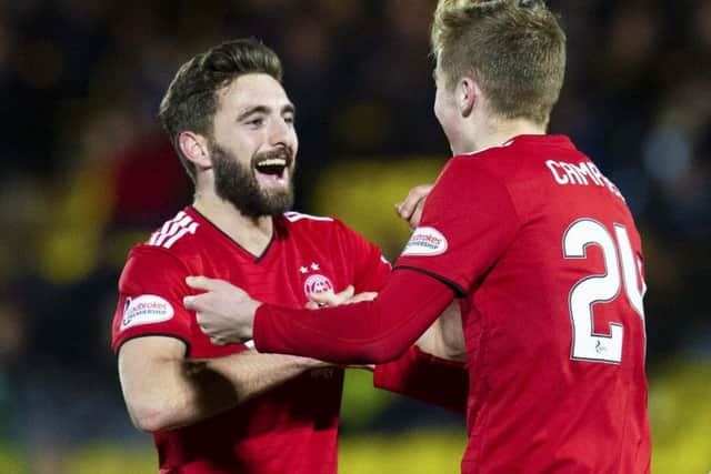 Graeme Shinnie, left, and Dean Campbell celebrate after a Steve Lawson own goal doubled Aberdeen's lead against Livingston. Picture: SNS