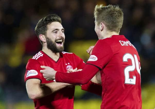Graeme Shinnie, left, and Dean Campbell celebrate after a Steve Lawson own goal doubled Aberdeen's lead against Livingston. Picture: SNS