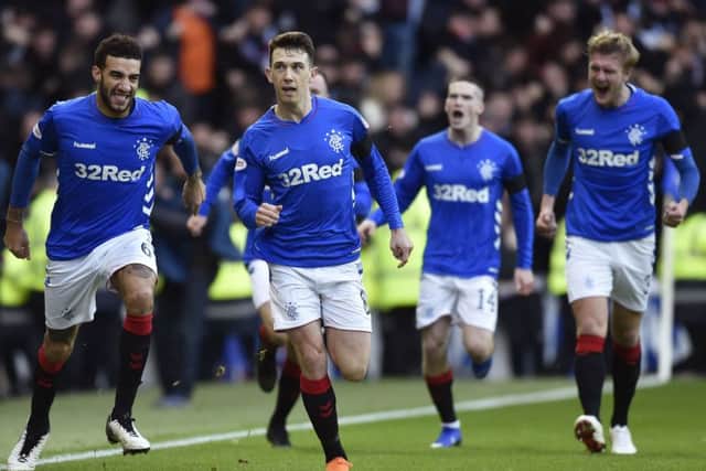 Rangers players run to congratulate Ryan Jack on the goal that decided Saturdays Old Firm clash at Ibrox. Picture: SNS.
