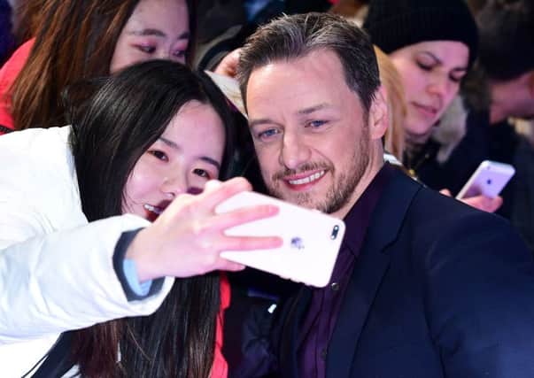 James McAvoy takes a photo with a fan during the Glass European Premiere. Picture: Ian West/PA Wire