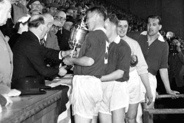 Freddie Glidden is presented with the Scottish Cup at Hampden in 1956