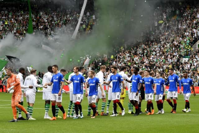 Celtic and Rangers players shake hands ahead of kick off. Picture: SNS