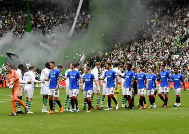 Celtic and Rangers players shake hands ahead of kick off. Picture: SNS