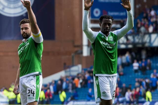 Darren McGregor and  Efe Ambrose salute Hibs fans after Hibs 3-2 victory at Ibrox last season. Picture: SNS.