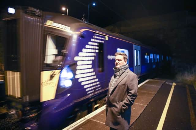 Robert Keenan at Musselburgh with one of the new Hitachi trains. Picture: Jon Savage