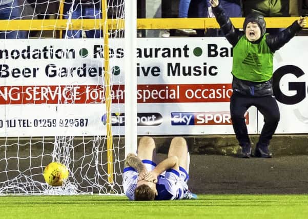 Kerr Waddell looks dejected after his clearance ended up in his own net to make it 2-1. Picture: SNS.