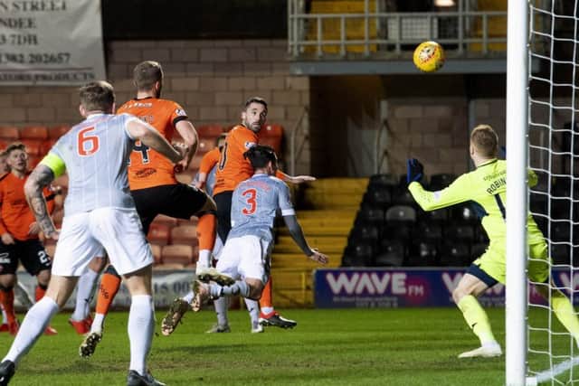 Nicky Clark flashes a header past goalkeeper Lee Robinson to move Dundee United to within three points of top spot in the Championship. Photograph: Alan Harvey/SNS