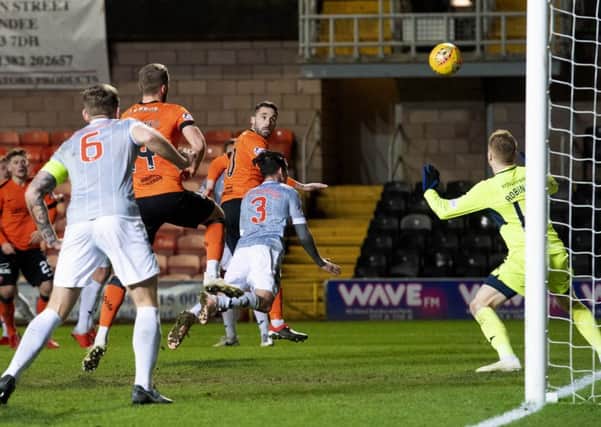 Nicky Clark flashes a header past goalkeeper Lee Robinson to move Dundee United to within three points of top spot in the Championship.  Photograph: Alan Harvey/SNS