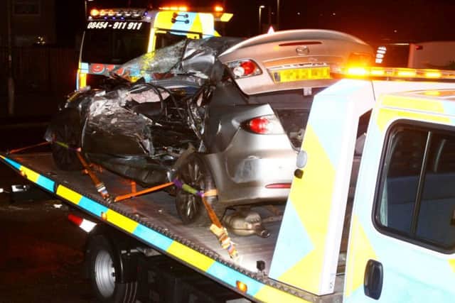 A dad was rushed to hospital after a bus smashed into his car and dragged it into a nearby house. Picture: SWNS