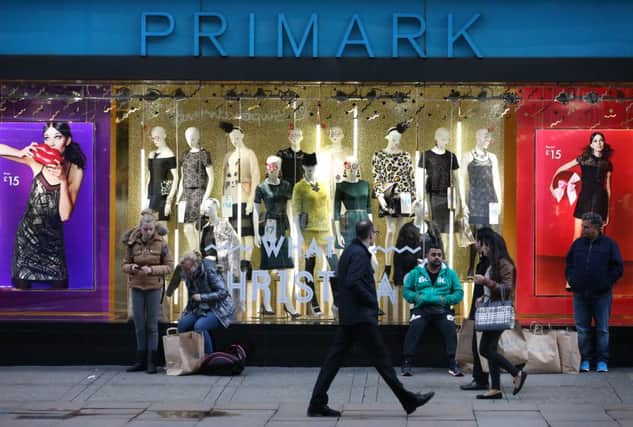 Customers wait with their purchases outside Primark's flagship store on Oxford Street. Picture: Peter Macdiarmid/Getty Images