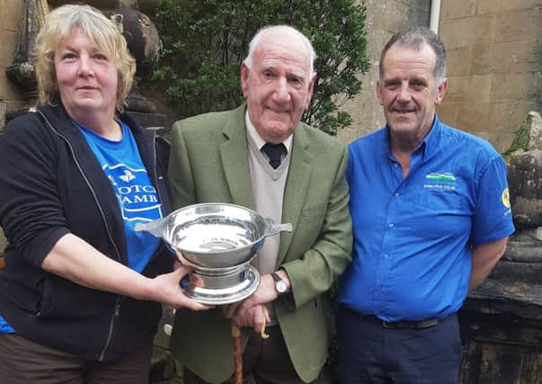 Argyll and the Islands Stalwart Award winner Sandy McKirdy receiving the award from John Dickson and Sybil MacPherson.