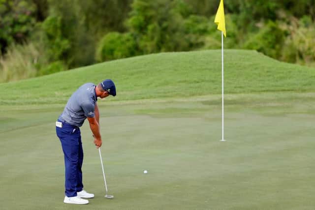 Bryson DeChambeau leaves the pin in place during the final round of the Sentry Tournament of Champions. Picture: Kevin C Cox/Getty Images)
