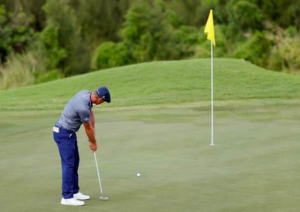 Bryson DeChambeau leaves the pin in place during the final round of the Sentry Tournament of Champions. Picture: Kevin C Cox/Getty Images)