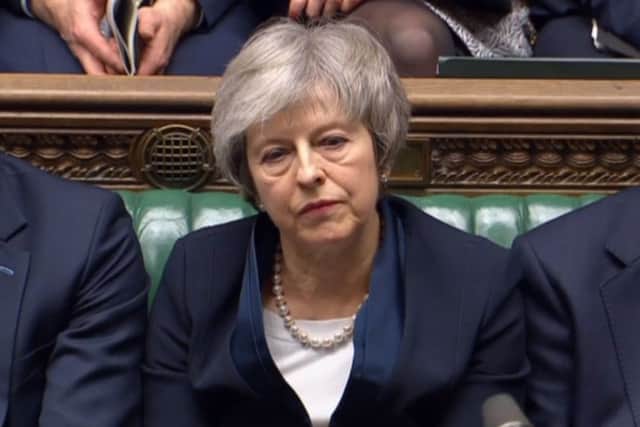 Prime Minister Theresa May listens to Labour leader Jeremy Corbyn speaking after losing a vote on her Brexit deal. Picture: House of Commons/PA Wire