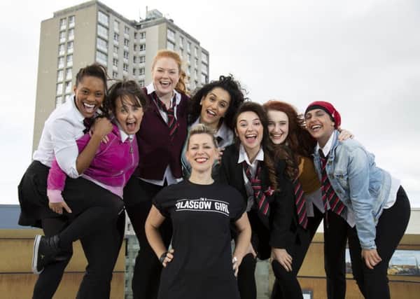 Cora Bissett in front with the cast of Glasgow Girls, left to right: 
Patricia Panther, Stephanie McGregor, Kara Swinney, Sophia Lewis, Chaira Sparks , Shannon Swan and Aryana Ramikhalawon