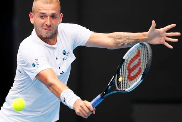 Dan Evans hits a return against Roger Federer. Picture: David Gray/AFP/Getty Images