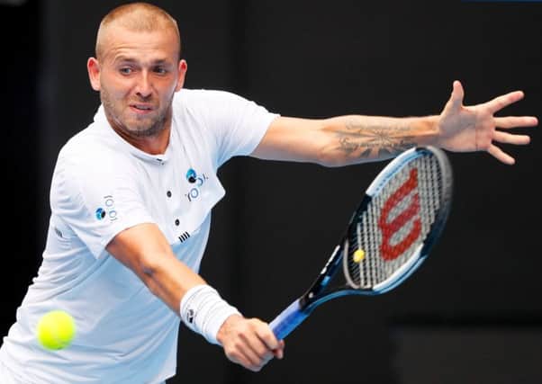 Dan Evans hits a return against Roger Federer. Picture: David Gray/AFP/Getty Images