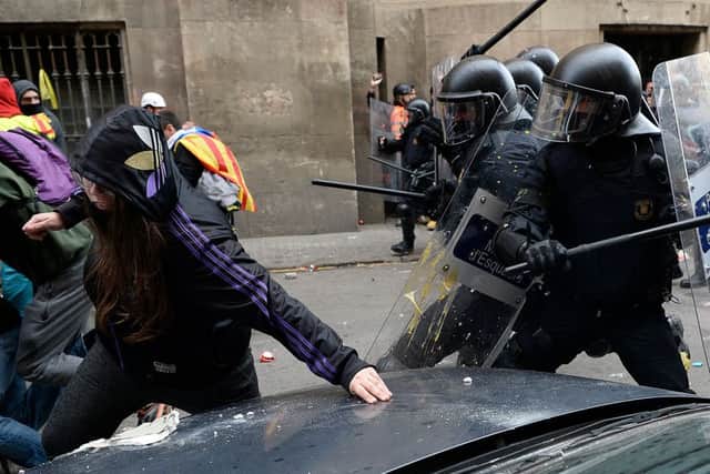 Catalan regional police clash with pro-independence protesters as the Spanish Cabinet meets in Barcelona last month (Picture: Josep Lago/AFP/Getty)