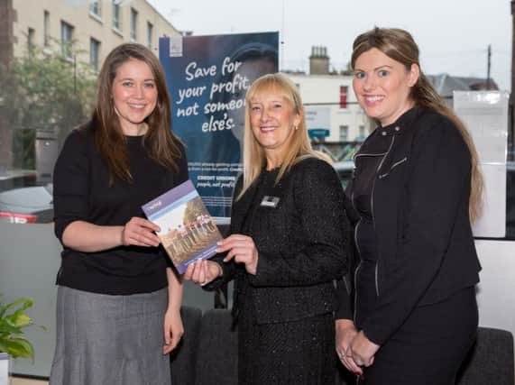 Aileen Campbell, left, helps launch the campaign at Capital Credit Union in November