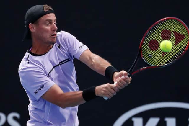 Lleyton Hewitt, in doubles action at Melbourne Park, claims that, for a year and a half, he has received threats from Bernard Tomic. Picture: Getty.
