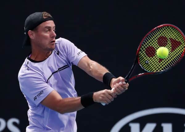 Lleyton Hewitt, in doubles action at Melbourne Park, claims that, for a year and a half, he has received threats from Bernard Tomic. Picture: Getty.