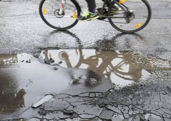 Potholes are among the most common reasons for complaints to councils. Picture: Ian Rutherford