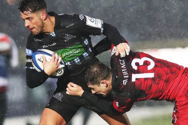 Adam Hastings, seen here holding off Lyons 
Pierre-Louis Barassi last month, is one of four changes to the Glasgow team for the Champions Cup showdown with Saracens. Picture: Ian MacNicol/Getty Images