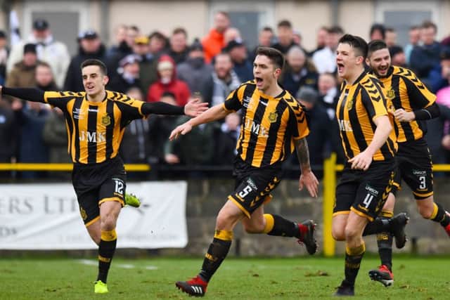 Talbot players celebrate after Craig McCracken's (centre) winner. Pic: SNS/Craig Williamson