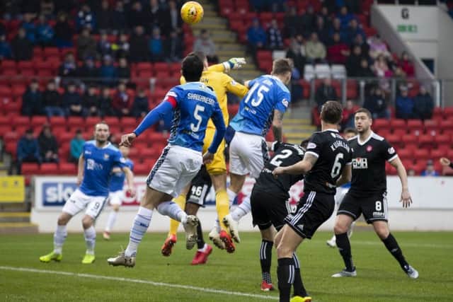 St Johnstone defender Jason Kerr beats Hamilton keeper Ryan Fulton to the ball to give the home side an early lead. Pic: SNS/Kenny Smith