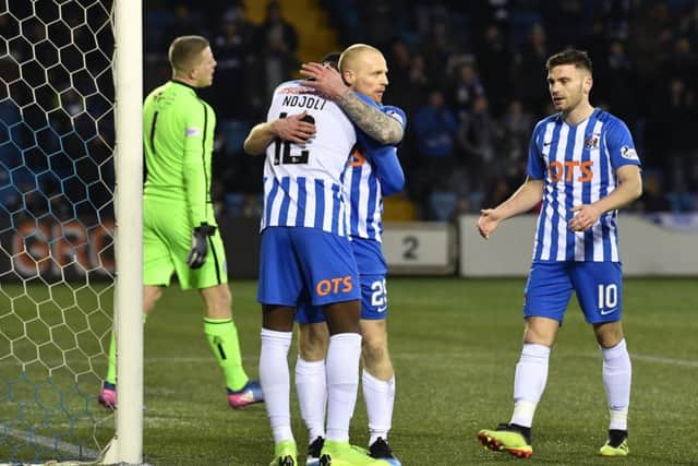 Chris Burke get s hug from team-mate Mikael Ndjoli to celebrate his goal/ Picture: SNS.