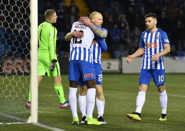 Chris Burke get s hug from team-mate Mikael Ndjoli to celebrate his goal/ Picture: SNS.