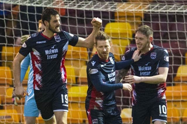 Brian Graham, left, celebrates after opening the scoring for Ross County: Picture: SNS.