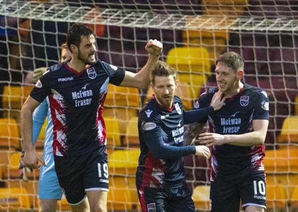 Brian Graham, left, celebrates after opening the scoring for Ross County: Picture: SNS.