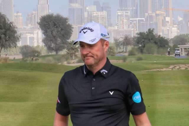Marc Warren sits second in a 36-hole shootout for three spots in Dubai.