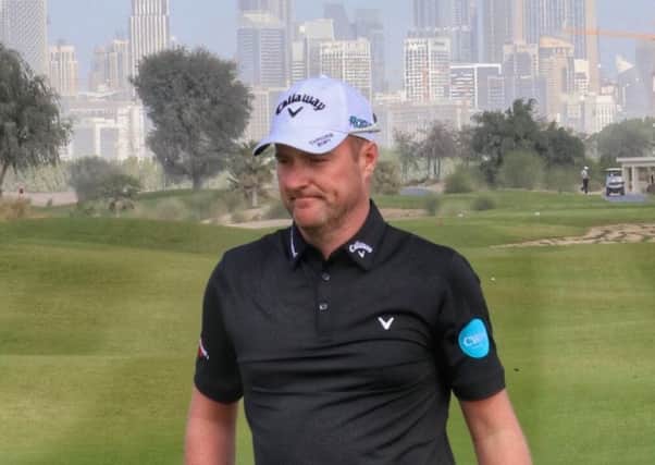 Marc Warren sits second in a 36-hole shootout for three spots in Dubai.